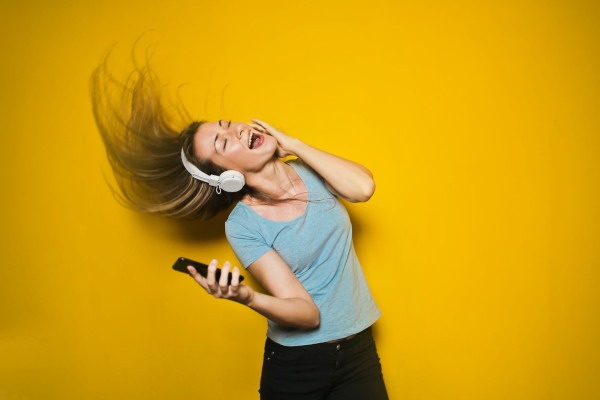 Woman Dancing to Music While Listening on Headphones